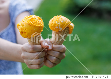 Refreshing ice cream in waffle cones with lemon flavour Refreshing ice cream in waffle cones with lemon flavour 105131571