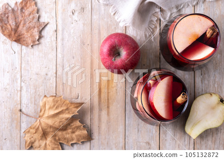 Autumn sangria with pear and apple on wooden table 105132872