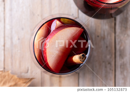 Autumn sangria with pear and apple on wooden table 105132873