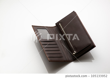 Close-up shot of a fashionable leather men's wallet on a white background with reflection Close-up shot of a fashionable leather men's wallet on a white background with reflection 105133952