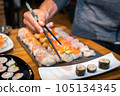 Overhead japanese sushi food. Maki ands rolls with tuna, salmon, shrimp, crab and avocado. Top view of assorted sushi. 105134345