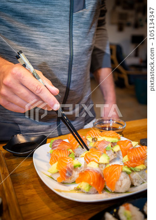 Overhead japanese sushi food. Maki ands rolls with tuna, salmon, shrimp, crab and avocado. Top view of assorted sushi. 105134347