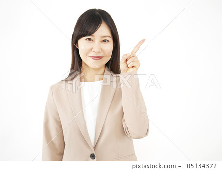 Middle-aged business woman pointing to the right White background Middle-aged business woman pointing to the right White background 105134372