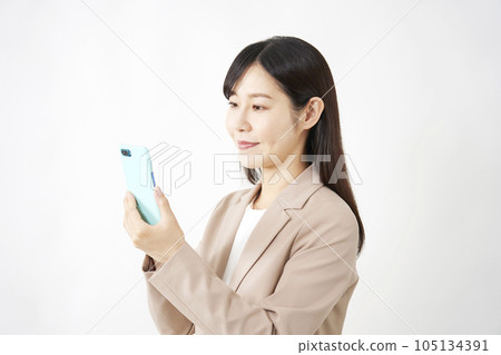 Middle-aged business woman using a smartphone White background 105134391