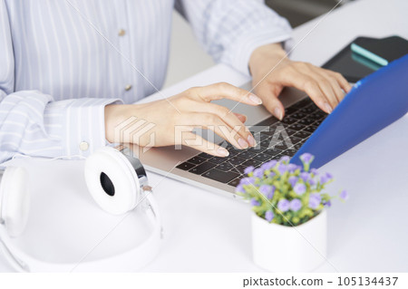 Business woman doing desk work using a laptop No face Business woman doing desk work using a laptop No face 105134437