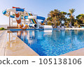 Empty small aquapark sliders with pool and palm trees at the morning, Tunisia 105138106