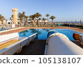 Empty small aquapark sliders with pool and palm trees at the morning, Tunisia 105138107