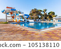Empty small aquapark sliders with pool and palm trees at the morning, Tunisia 105138110