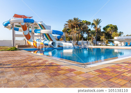 Empty small aquapark sliders with pool and palm trees at the morning, Tunisia 105138110