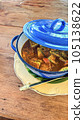Thai style curry with fired egg in blue pot on wooden table. 105138622