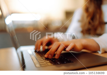 Close-up picture of female hands working on laptop. Social networking technology concept. Lifestyle. 105138699