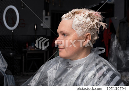 Painted head of adult pretty Caucasian woman in white portrait of a girl hair care in salon 105139794