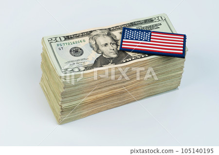 American flag on pile of 20 dollar banknote 105140195