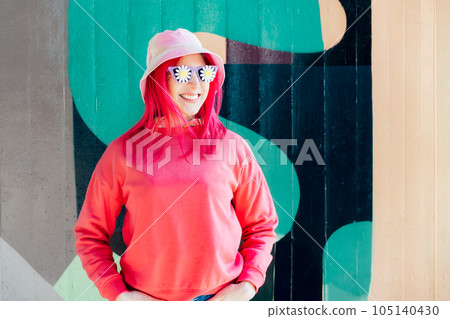 Happy smiling woman in sunglasses with flowers stickers. Woman with pink hair,bucket hat and magenta sweatshirt posing on graffiti wall background. Vanilla Girl. Kawaii vibes. Candy colors design 105140430