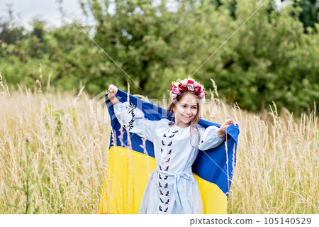 Ukraines Independence Flag Day. Constitution day. Ukrainian child girl in embroidered shirt vyshyvanka with yellow and blue flag of Ukraine in field. flag symbols of Ukraine. Kyiv, Kiev day Ukraines Independence Flag Day. Constitution day. Ukrainian child girl in embroidered shirt vyshyvanka with yellow and blue flag of Ukraine in field. flag symbols of Ukraine. Kyiv, Kiev day 105140529