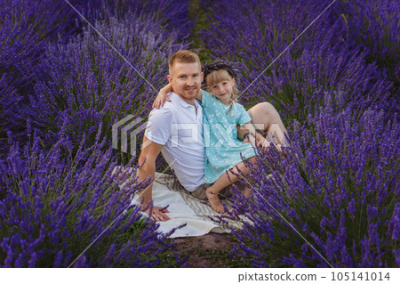 father and daughter on a picnic in a lavender field father and daughter on a picnic in a lavender field 105141014
