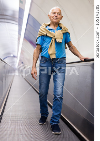 Elderly man going down to subway station 105141885
