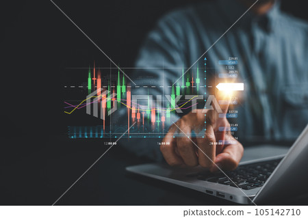 Investment strategy and progress concept. Trader's hand points at a virtual hologram stock on a screen, showcasing the path to business growth and success through strategic investment planning. Investment strategy and progress concept. Trader's hand points at a virtual hologram stock on a screen, showcasing the path to business growth and success through strategic investment planning. 105142710
