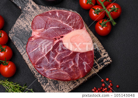 Fresh raw beef steak with bone or ossobuco with salt, spices and herbs 105143048