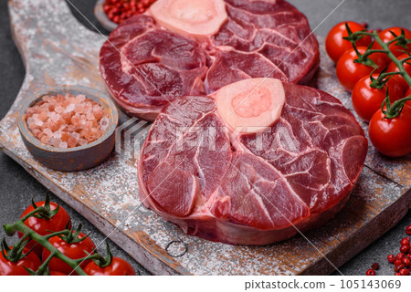 Fresh raw beef steak with bone or ossobuco with salt, spices and herbs 105143069