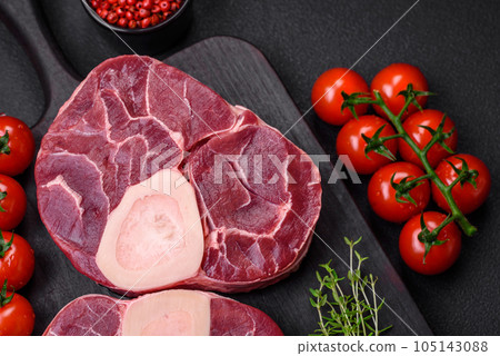 Fresh raw beef steak with bone or ossobuco with salt, spices and herbs 105143088