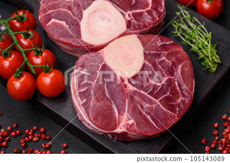Fresh raw beef steak with bone or ossobuco with salt, spices and herbs Fresh raw beef steak with bone or ossobuco with salt, spices and herbs 105143089