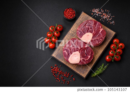 Fresh raw beef steak with bone or ossobuco with salt, spices and herbs 105143107