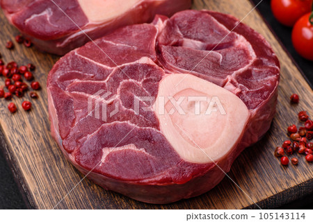 Fresh raw beef steak with bone or ossobuco with salt, spices and herbs 105143114