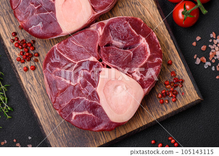 Fresh raw beef steak with bone or ossobuco with salt, spices and herbs 105143115