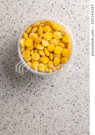 Lupini beans in brine. Pickled lupin in bowl on kitchen table. Top view. 105143297