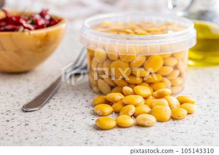 Lupini beans in brine. Pickled lupin in bowl on kitchen table. Lupini beans in brine. Pickled lupin in bowl on kitchen table. 105143310
