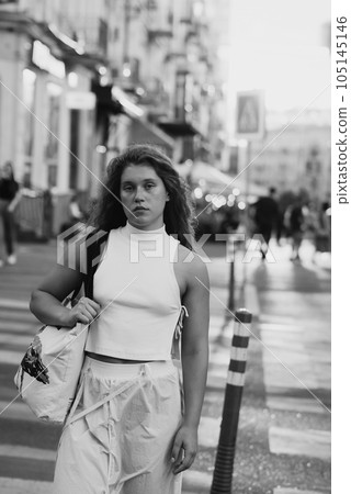 A street black and white portrait of a beautiful young woman 105145146