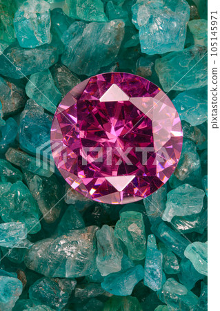 amethyst diamonds diamond on placed on a pile of raw sky blue gemstones..jewelry are lovely present for valentine day.colorful raw stone background.lived a life of luxury. 105145971