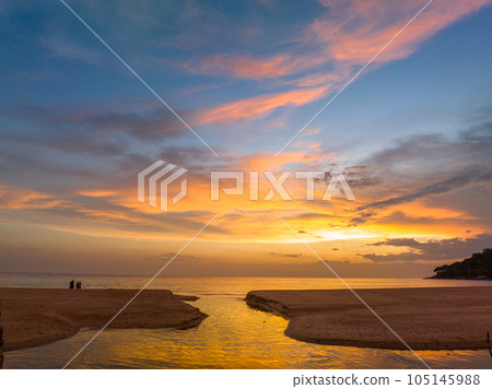 .aerial view stunning reflection of bright golden sky in a canal at Karon beach Phuket. .aerial view stunning reflection of bright golden sky in a canal at Karon beach Phuket. 105145988