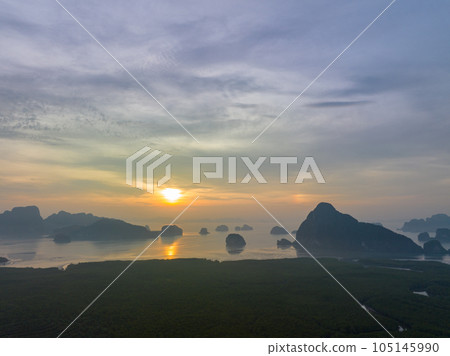 aerial view Amazing light of nature cloudscape sky above Samed Nang Chee Phang Nga archipelago. .Imagine a fantasy bright red sky at sunrise from a bird's eye view..tropical landscape background. 105145990