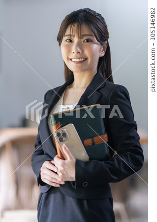 Young business woman with a notebook to do business Young business woman with a notebook to do business 105146982