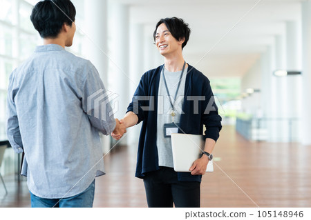 Young male engineer shaking hands in the office 105148946