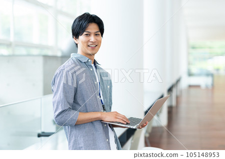 Young male engineer working on a computer in the office Young male engineer working on a computer in the office 105148953