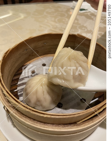 Steamed xiao long bao (soup dumplings) in a bamboo steamer - Dim sum from Yokohama Chinatown Steamed xiao long bao (soup dumplings) in a bamboo steamer - Dim sum from Yokohama Chinatown 105149780