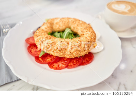 Turkish breakfast with simit, cheese, tomato, cucumber, olives. Breakfast with coffee in the restaurant. Morning nutritious meal 105150294
