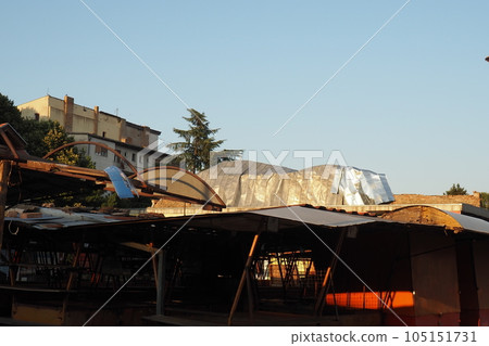 Aftermath of the hurricane 07,19,23 Sremska Mitrovica, Serbia. An aluminum sheet, a ripped roof that flew off onto a brick building. Metal decking sheet. State of emergency after a catastrophic storm Aftermath of the hurricane 07,19,23 Sremska Mitrovica, Serbia. An aluminum sheet, a ripped roof that flew off onto a brick building. Metal decking sheet. State of emergency after a catastrophic storm 105151731