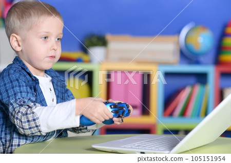 Happy boy playing video game at home 105151954
