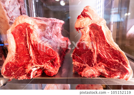 Fresh chunk of raw Florentine T bone beef meat for sale in restaurant chiller in Florence, Italy 105152119