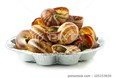 plate of baked escargot snails filled with parsley and garlic butter plate of baked escargot snails filled with parsley and garlic butter 105153650
