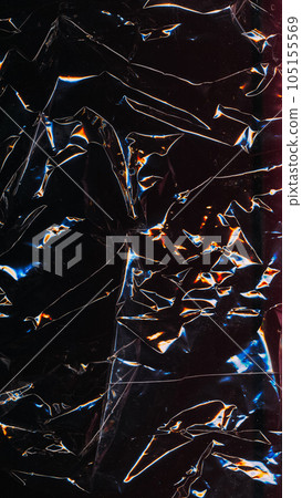 Grunge texture. Old film. Abstract background. Wrinkled black paper with yellow blue neon glowing glitch pattern on dark light shadow. 105155569