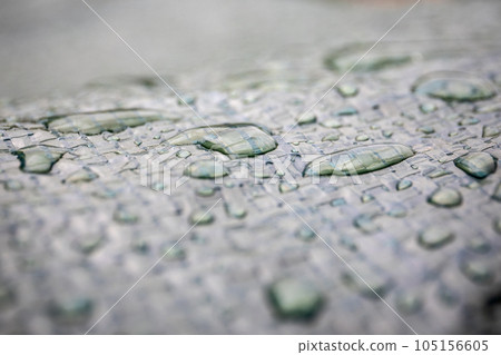 Water drops on a dark awning. Texture and close-up Water drops on a dark awning. Texture and close-up 105156605