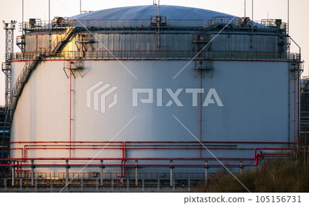 An oil tank is on the coast of industrial port An oil tank is on the coast of industrial port 105156731