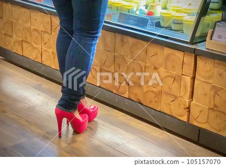Legs of a shopping woman wearing jeans and high heels 105157070