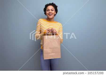 afro brunette latin young woman holding craft gift bag afro brunette latin young woman holding craft gift bag 105157200