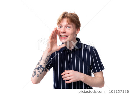 close-up portrait of a stylish handsome young blond man keeping a secret on a white background close-up portrait of a stylish handsome young blond man keeping a secret on a white background 105157326